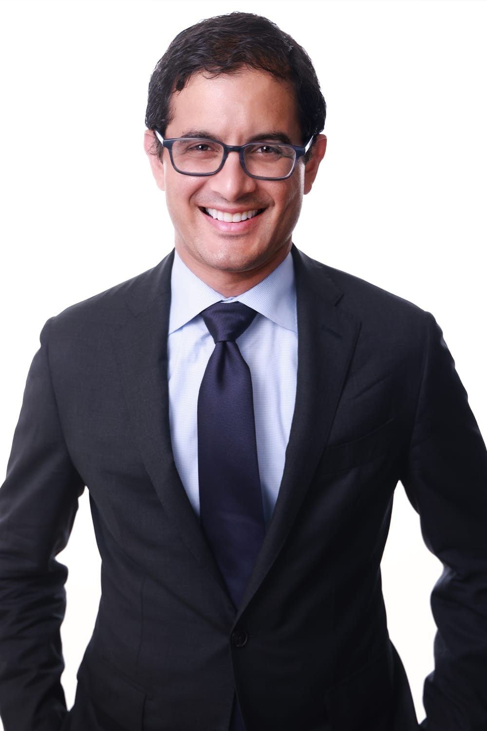 A smiling man in a suit and tie with professional headshots.