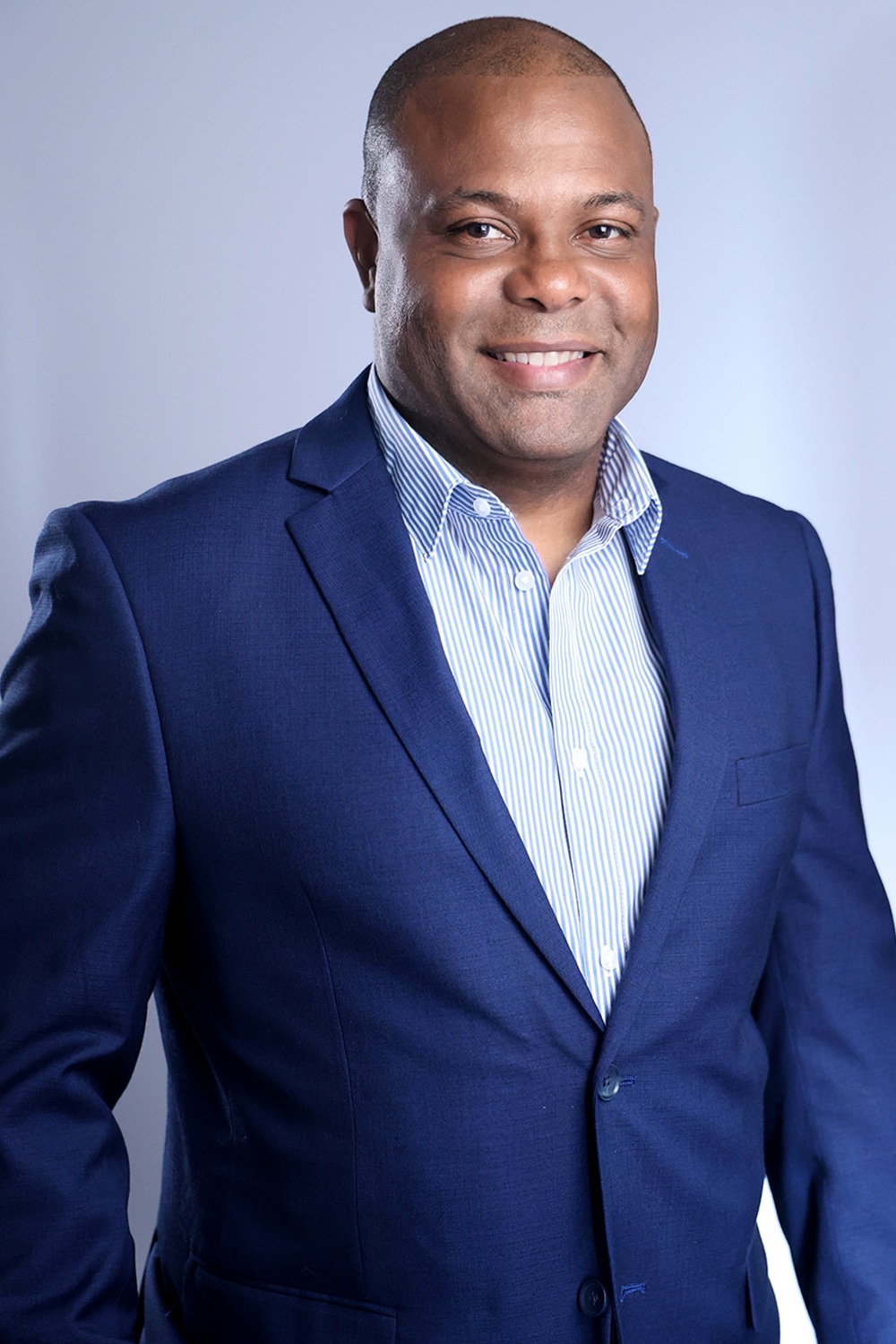 african american man in a blue suit posing for headshots in nyc